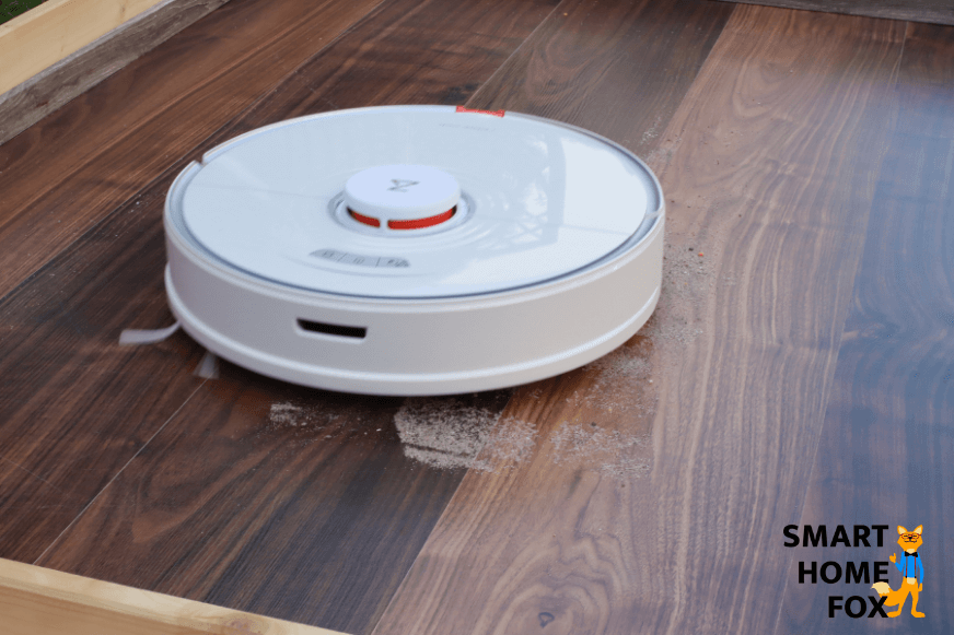 Der Roborock S7 Saugroboter saugt Sand auf einem Hartboden